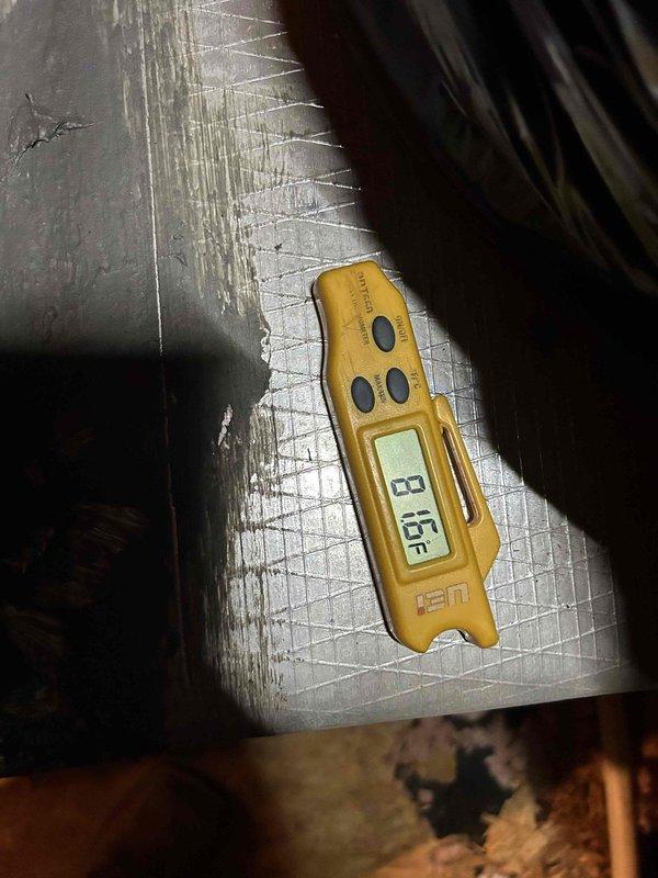 Responded to no cooling complaint on 4-year-old heat pump system with attic-mounted air handler displaying thermostat error code. Upon inspection, discovered severely frozen evaporator coil with heavy ice accumulation across entire coil surface. Measured supply air temperature at 45°F and superheat at 6°F, confirming restricted airflow condition causing coil to ice over and preventing proper heat exchange. Diagnostic findings indicate inadequate airflow due to either dirty coil, blower motor failure, or refrigerant system issue requiring further evaluation after coil defrost.