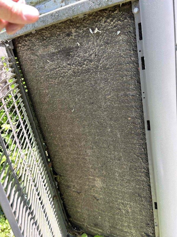 Responded to no cooling complaint on residential air conditioning system. Upon inspection, found extremely restricted airflow due to heavily clogged air filter completely saturated with dust and debris. Removed and replaced filter, which had accumulated significant buildup indicating extended period without maintenance. Inspected electrical components including dual-run capacitor rated at 45+10 MFD, 440VAC, which tested within acceptable parameters. System restored to normal cooling operation following filter replacement and airflow verification.