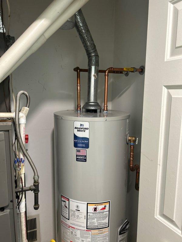 Removed existing water heater and installed new Bradford White 50-gallon natural gas water heater with 40,000 BTU/hr input capacity. Completed all necessary plumbing connections using copper piping with proper shut-off valves, installed exhaust venting system, and verified all safety controls and gas connections were functioning properly per manufacturer specifications and ANSI Z21.10.1-2019/CSA 4.1-2019 standards.