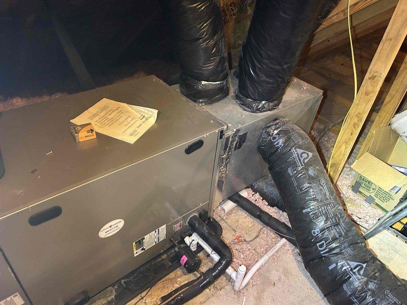 Responded to no cooling complaint on 12-year-old heat pump system with thermostat set to 73°F and actual temperature reading 81°F. Accessed attic-mounted air handler unit to perform diagnostic evaluation of system components, measuring clearances and inspecting ductwork connections, refrigerant lines, and electrical connections. Documented equipment condition and installation configuration with measurements to determine cause of cooling failure and provide repair recommendations.