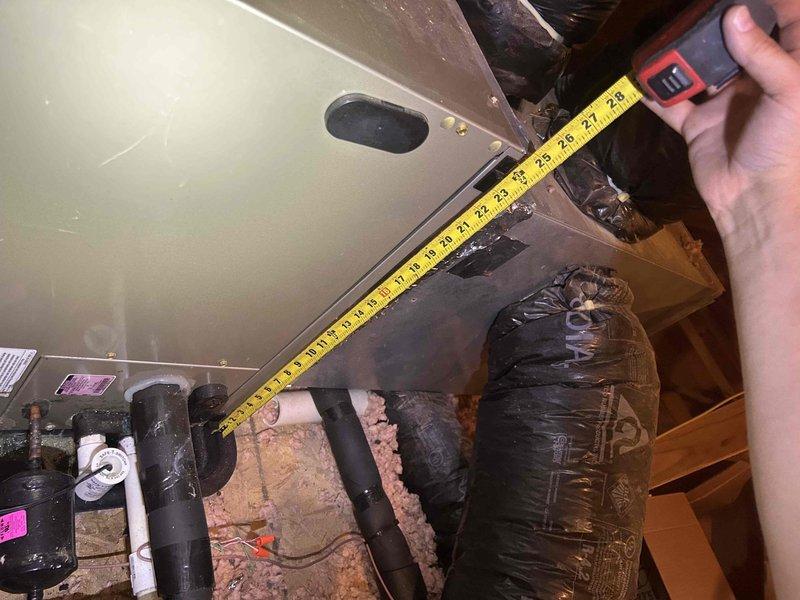 Responded to no cooling complaint on 12-year-old heat pump system with thermostat set to 73°F and actual temperature reading 81°F. Accessed attic-mounted air handler unit to perform diagnostic evaluation of system components, measuring clearances and inspecting ductwork connections, refrigerant lines, and electrical connections. Documented equipment condition and installation configuration with measurements to determine cause of cooling failure and provide repair recommendations.