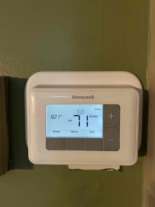 Responded to warranty call for recently installed HVAC system that would not power on and displayed orange triangle error on Honeywell thermostat. Performed diagnostic testing using Fieldpiece SMAN manifold gauge, verified refrigerant pressures and system charge on FR454B refrigerant, confirmed proper system operation with cooling mode activated and pressures within normal range. System restored to full functionality with thermostat displaying correct temperature readings and cooling status.