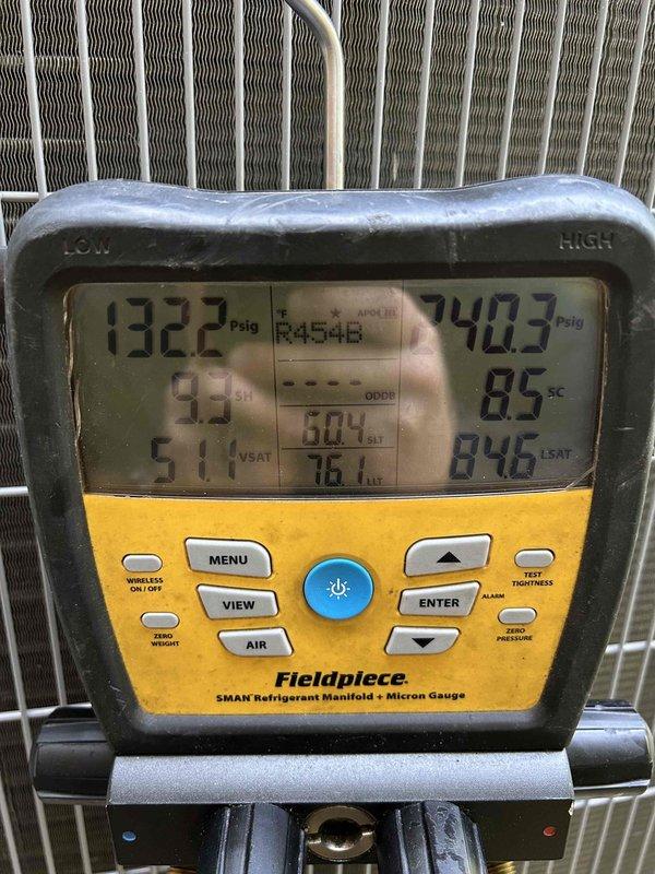 Responded to warranty call for recently installed HVAC system that would not power on and displayed orange triangle error on Honeywell thermostat. Performed diagnostic testing using Fieldpiece SMAN manifold gauge, verified refrigerant pressures and system charge on FR454B refrigerant, confirmed proper system operation with cooling mode activated and pressures within normal range. System restored to full functionality with thermostat displaying correct temperature readings and cooling status.