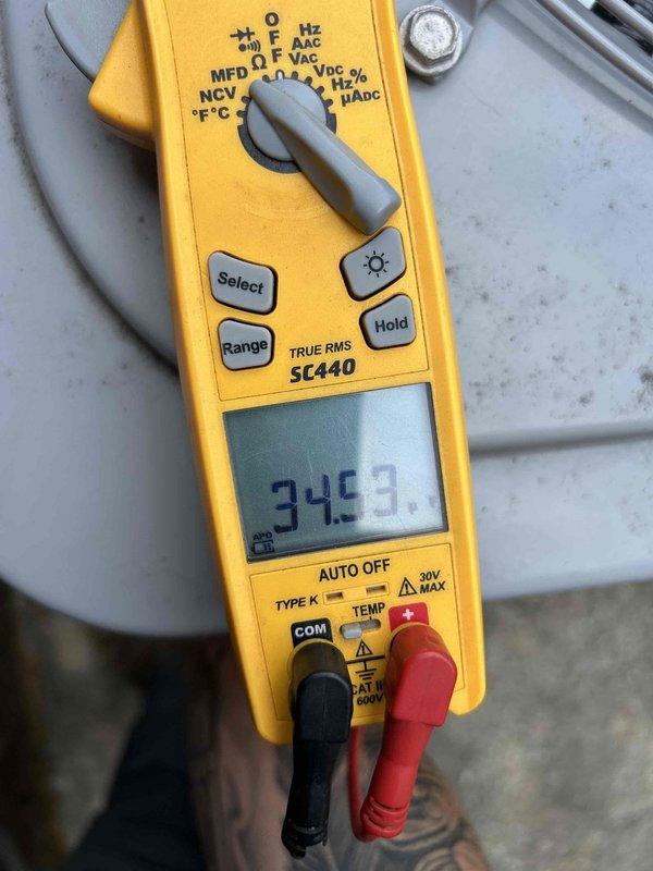 Completed comprehensive maintenance tune-up on dual heat pump and air handler system as part of club membership care plan. Upon inspection, discovered heavily soiled air filter with significant dust and debris accumulation, indicating extended use without replacement; filter exhibited dark staining and particulate buildup restricting airflow. Measured electrical parameters using clamp meter, recording operating amperage of 34.53 amps on system components. Performed standard maintenance procedures including visual inspection of all accessible components, verified electrical connections, and documented system condition with photographic evidence showing filter contamination and rust staining on equipment base indicating potential moisture exposure.