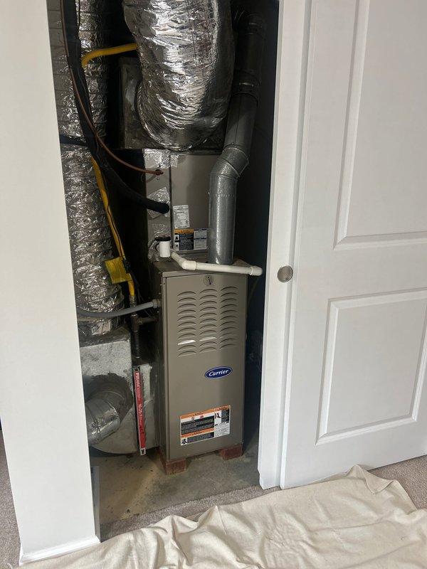 Completed comprehensive AC tune-up on Carrier air conditioning and gas furnace system located in garage utility closet. Performed routine maintenance inspection including checking refrigerant levels, cleaning condenser coils, inspecting electrical connections, testing thermostat operation, verifying proper condensate drain function through PVC drainage system, and examining flex ductwork connections for secure sealing. System operational and running efficiently with no issues identified during service visit.