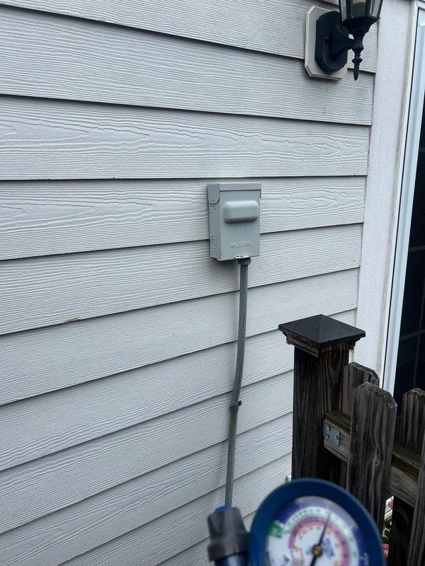 Performed comprehensive HVAC system replacement at residential property. Removed existing air conditioning unit and installed new cylindrical condenser unit on concrete pad adjacent to house exterior. Connected refrigerant lines with proper fittings, installed electrical disconnect box on exterior wall, and ran necessary conduit for power supply. Charged system with refrigerant, verified proper pressures using manifold gauges, and tested all electrical connections. System operational and running within manufacturer specifications upon completion.