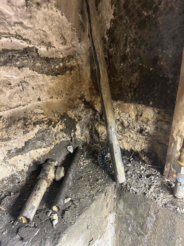 Responded to service call for sump pump testing and water shutoff valve evaluation in 87-year-old residential basement following home inspection findings. Conducted comprehensive assessment of sump pump functionality and operational capacity in deteriorated basement environment showing extensive water damage, mold growth, and structural decay. Inspected water shutoff valve in separate basement area for active leaking and determined replacement requirements. Both plumbing components exhibited age-related deterioration consistent with the home's construction era, with significant accumulation of sediment, debris, and moisture damage evident throughout the work areas. Documented existing conditions through photographic evidence showing compromised surfaces, corroded piping, and environmental degradation requiring immediate attention to prevent further water intrusion and potential flooding risks.