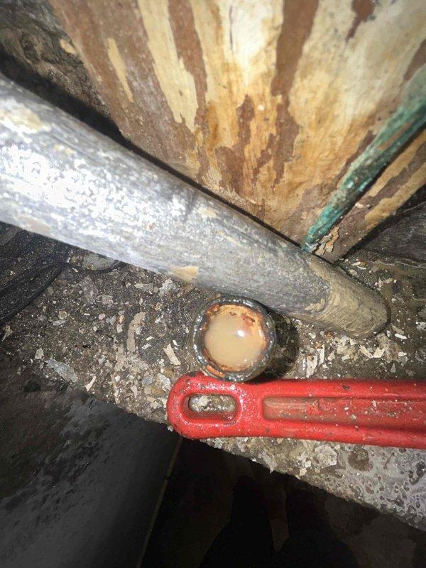 Responded to service call for sump pump testing and water shutoff valve evaluation in 87-year-old residential basement following home inspection findings. Conducted comprehensive assessment of sump pump functionality and operational capacity in deteriorated basement environment showing extensive water damage, mold growth, and structural decay. Inspected water shutoff valve in separate basement area for active leaking and determined replacement requirements. Both plumbing components exhibited age-related deterioration consistent with the home's construction era, with significant accumulation of sediment, debris, and moisture damage evident throughout the work areas. Documented existing conditions through photographic evidence showing compromised surfaces, corroded piping, and environmental degradation requiring immediate attention to prevent further water intrusion and potential flooding risks.