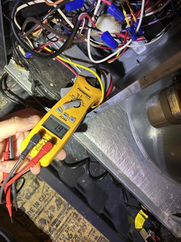 Completed routine air conditioning tune-up on an eight-year-old cooling system with air handler located in attic. Performed comprehensive maintenance inspection including electrical testing of blower motor components, which measured 1.93 amps, and verified proper operation of condensate drain system with clear inspection port. All system components inspected and found operating within normal parameters.