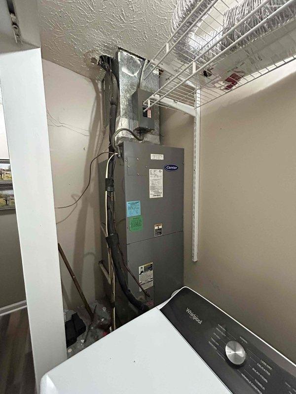 Responded to no-cooling complaint on 17-year-old Carrier electric HVAC system located in utility room. Upon arrival, unit was off due to evaporator coil freeze-up occurring over previous several days. Performed diagnostic evaluation and confirmed suspected refrigerant leak. Documented system condition including deteriorated wooden structural support elements near installation area showing significant moisture damage and wood rot. Recommended system replacement due to age, refrigerant leak, and compromised installation integrity.