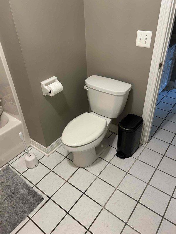Responded to ongoing toilet leak in residential bathroom of 20+ year old home. Upon inspection, identified failed water supply line connection at fill valve with visible corrosion and seepage at floor-mounted shutoff valve. Replaced deteriorated braided supply line and corroded angle stop valve. Cleaned residual staining from tile flooring around connection point, tested system for proper operation and verified no additional leaks present.