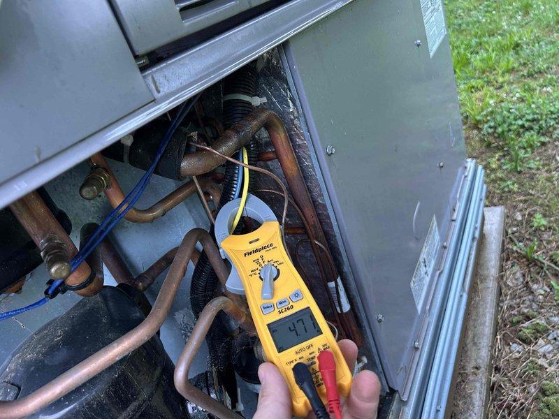 Completed comprehensive maintenance tune-up on heat pump package unit with propane backup located on exterior side of residence. Performed electrical diagnostics on internal components using digital multimeter, inspected heavily oxidized copper refrigerant lines showing age-related patina, and verified system operation with supply air temperature measuring 53°F at interior floor register. All components tested within acceptable parameters for continued operation under club maintenance agreement.