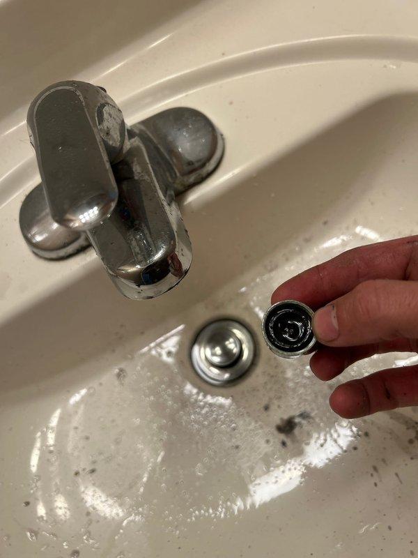 Responded to callback for women's bathroom sink with no water flow following previous repair work on pipe tip and running toilet. Upon diagnosis, removed and inspected faucet aerator which was found to be clogged with debris and sediment. Cleaned aerator thoroughly, reinstalled component, and restored full water flow to sink. Tested faucet operation to confirm proper function.
