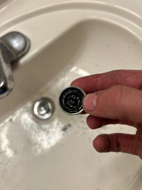 Responded to callback for women's bathroom sink with no water flow following previous repair work on pipe tip and running toilet. Upon diagnosis, removed and inspected faucet aerator which was found to be clogged with debris and sediment. Cleaned aerator thoroughly, reinstalled component, and restored full water flow to sink. Tested faucet operation to confirm proper function.