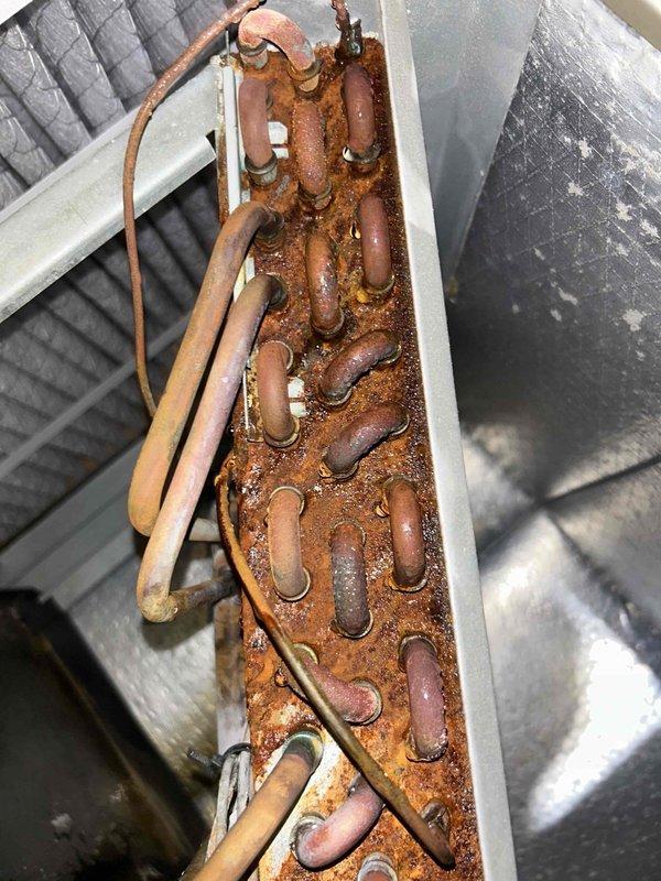 Completed preventive maintenance tune-up on geothermal HVAC system with indoor unit located in attic and outdoor unit in basement. Inspected both units and documented significant corrosion present on copper refrigerant lines, metal housings, and manifold components, indicating prolonged moisture exposure and system age. Noted extensive rust and oxidation on piping, connections, and metal channels throughout both the basement and attic equipment, with particular deterioration at pipe bends and fittings. Performed standard maintenance procedures including system inspection and operational testing. Customer provided filters as arranged. Advised customer of advanced corrosion conditions observed on multiple system components that may require future attention to prevent potential system failures or refrigerant line integrity issues.