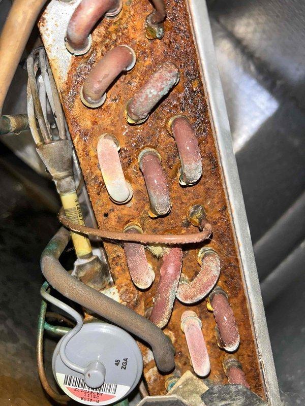 Completed preventive maintenance tune-up on geothermal HVAC system with indoor unit located in attic and outdoor unit in basement. Inspected both units and documented significant corrosion present on copper refrigerant lines, metal housings, and manifold components, indicating prolonged moisture exposure and system age. Noted extensive rust and oxidation on piping, connections, and metal channels throughout both the basement and attic equipment, with particular deterioration at pipe bends and fittings. Performed standard maintenance procedures including system inspection and operational testing. Customer provided filters as arranged. Advised customer of advanced corrosion conditions observed on multiple system components that may require future attention to prevent potential system failures or refrigerant line integrity issues.