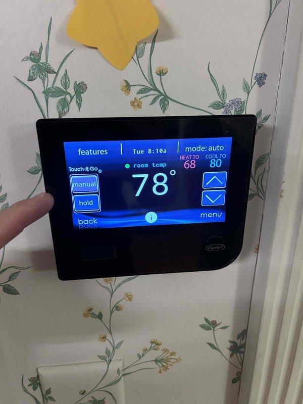 Completed comprehensive Care Plan tune-up on dual-zone HVAC system with equipment located in attic and basement. Performed preventive maintenance on Carrier CNPVP4821ALAMAA unit (2010 installation) utilizing R-410A Puron refrigerant, verified system pressures at 450 PSIG design specification, and inspected all components for proper operation. Customer supplied humidifier pad for replacement during service visit. Verified thermostat programming and operation on Carrier digital touchscreen unit, confirming auto mode functionality with heat set to 68°F and cool set to 80°F, with room temperature reading 68°F at time of service. Both attic and basement systems inspected, serviced, and confirmed operational per manufacturer specifications.