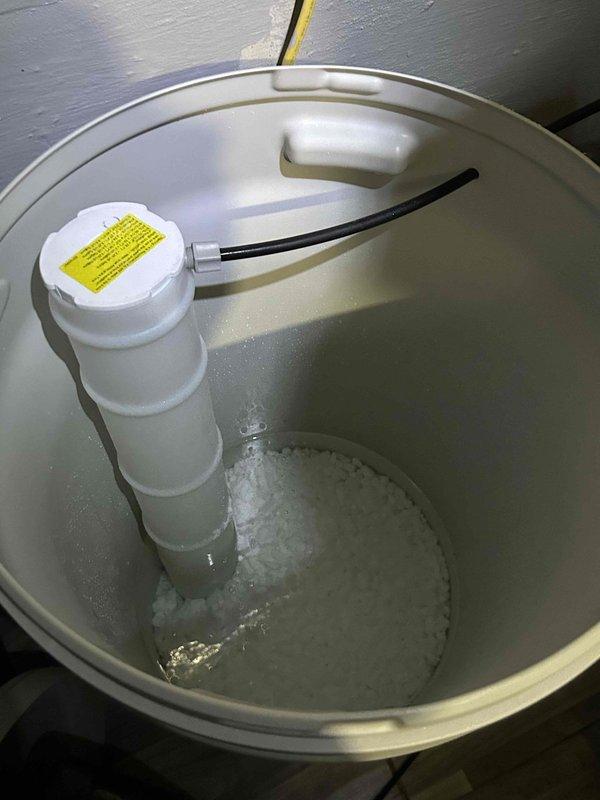 Performed comprehensive diagnostic service on water softener system in coordination with manufacturer technical support. Diagnosed and repaired QCRO leaking line and secured loose faucet. Conducted full system analysis including overrun total assessment, meter totalizer reset, and regeneration frequency adjustment for continued monitoring. Inspected system for downstream flow leaks and verified brine valve operation for potential leakage issues. Evaluated and confirmed regeneration capacity settings against daily water usage patterns, checked actual refill flow velocity and end cycle volume measurements, and verified metering accuracy using point of entry house meter. Confirmed all settings were appropriate for selected salt setting and unit size. Replenished salt supply in brine tank and removed equipment from site upon completion.