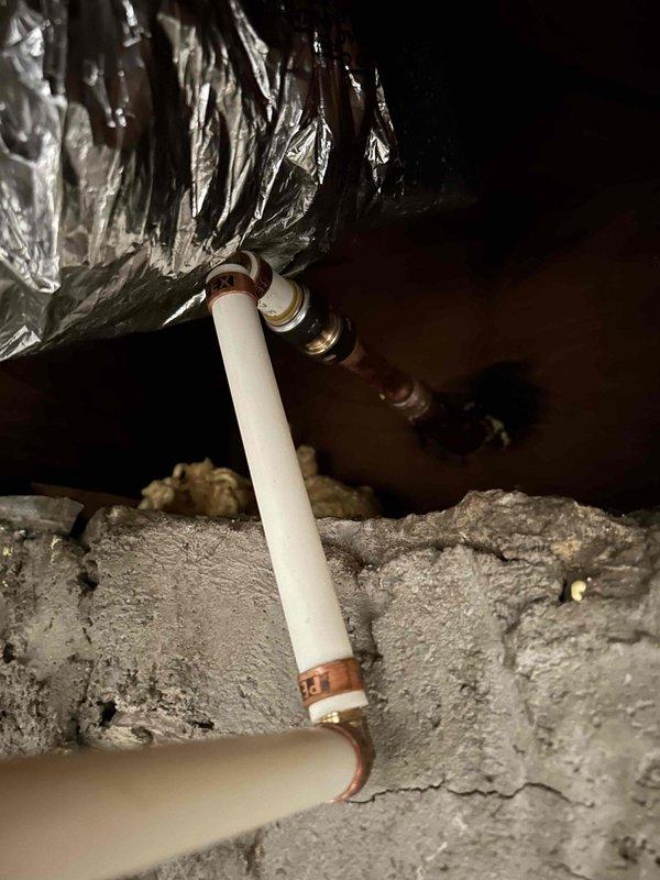 Responded to non-functional outdoor spigot at 70-year-old residence where fixture had been inoperative for several months. Upon inspection, identified failed hose bib mounted on exterior brick wall above concrete foundation. Accessed supply line from crawl space, locating copper piping and PVC connections behind wall assembly. Removed deteriorated outdoor spigot and assessed mounting location showing signs of age-related wear and moisture exposure at foundation level. Installed new frost-free self-draining hose bib as requested to prevent future freeze damage, ensuring proper pitch for automatic drainage when shut off. Secured fixture to brick wall with appropriate masonry anchors and verified supply line connections in crawl space remained secure. Tested new spigot for proper operation, confirming water flow and automatic drain-back function when valve closed. Documented installation with photographs showing completed exterior fixture and associated crawlspace plumbing connections.