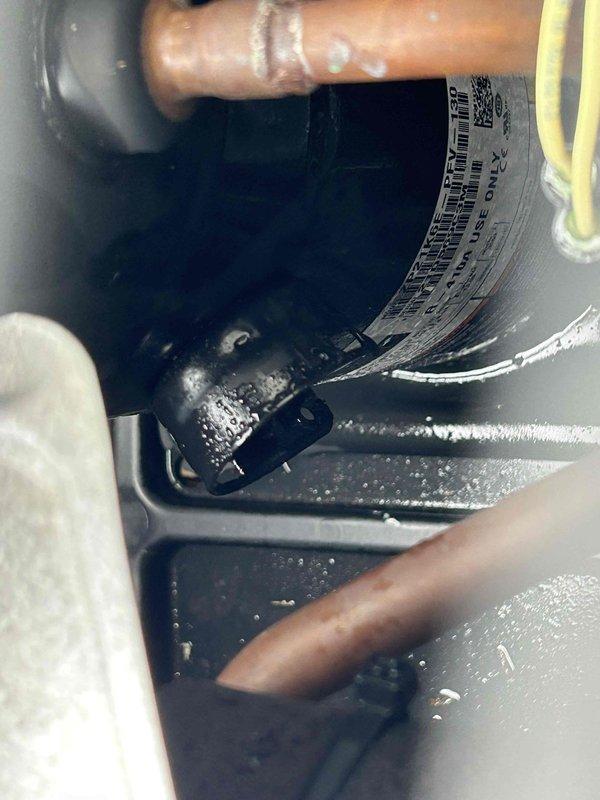 Responded to no cooling complaint on 4-year-old electric air conditioning system with indoor unit located in attic. Upon arrival, system was in off position following previous diagnostic visit by another company. Performed comprehensive system evaluation including visual inspection of outdoor condensing unit and indoor air handler components. Inspected compressor, refrigerant lines, electrical connections, and evaporator coil assembly. Noted accumulation of dirt and debris on compressor unit, mounting surfaces, and condenser coil fins indicating need for routine maintenance. Examined copper refrigerant piping showing normal oxidation consistent with system age. Verified all electrical connections secure with proper wire management and zip tie restraints in place. Assessed capacitor, accumulator, and associated refrigerant circuit components for proper operation. Documented system condition through photographic evidence showing compressor assembly, piping configuration, and evaporator c