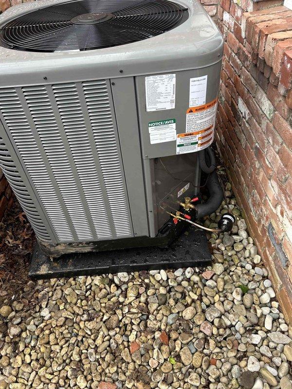 Completed full residential HVAC system replacement with installation of a RUUD 3.5 ton, 14.3 SEER2 two-stage heat pump system consisting of RP14AY42AJ2NA outdoor unit and RH2TY4821STANNJ air handler with 15kW auxiliary heat kit. Removed and properly disposed of existing equipment, secured all applicable permits, and installed new system in attic space with outdoor condenser positioned on equipment pad against exterior brick wall. Installation included non-fused disconnect, electrical whip, refrigerant line set with service valves, filter rack, auxiliary drain pan, condensate safety switches, E-Z-Trap with brush, and wireless-compatible digital thermostat for zone control capability. System was charged, tested, and verified operational with all safety controls functioning properly per manufacturer specifications and local code requirements.