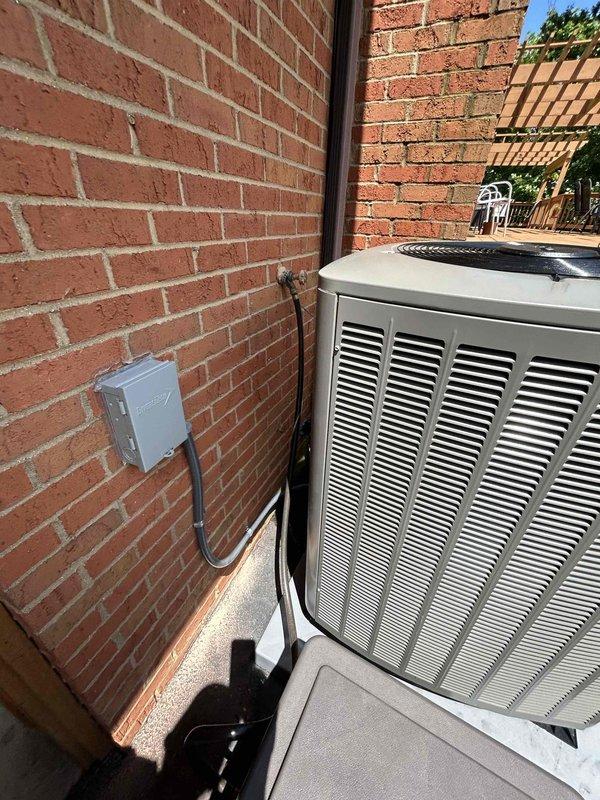 Completed full residential HVAC system replacement with installation of a Lennox 4-ton, 19 SEER variable-speed heat pump system. Removed and properly disposed of existing equipment per code requirements. Installed outdoor condensing unit on new equipment pad with snow legs in side yard location between structures. Mounted gray electrical disconnect box on exterior brick wall with proper conduit and electrical whip connection to unit. Applied refrigerant line insulation and installed refrigerant line filter for system protection.

Indoor installation included new evaporator coil with transition to existing ductwork and standard-sized air filter rack. Integrated Aprilaire humidifier unit into ductwork system with flexible metallic ducting connection. Installed comprehensive drain safety system including trap, SS2 coil drain safety water sensor, and "Ceiling Saver" overflow drain pan with water sensor to prevent water damage. All components properly secured and sealed per manufacturer spe