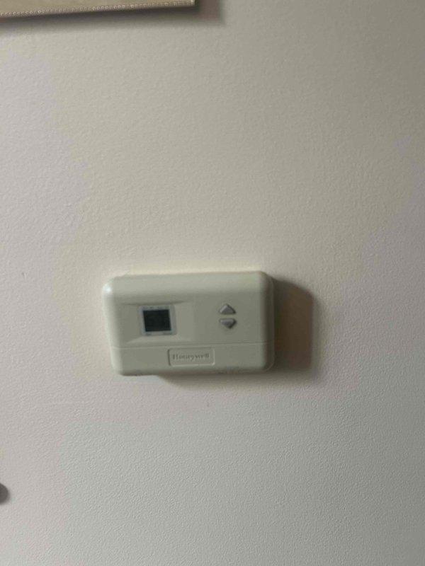 Responded to no cooling complaint on 20-year-old electric air conditioning system serving main level of residence. Performed comprehensive system evaluation of outdoor condensing unit and indoor air handler located in basement. Documented current equipment condition including weathered outdoor unit with debris accumulation and existing Honeywell thermostat. Based on system age exceeding manufacturer life expectancy and non-operational cooling status, provided full HVAC replacement estimate as GREEN option for complete system upgrade.