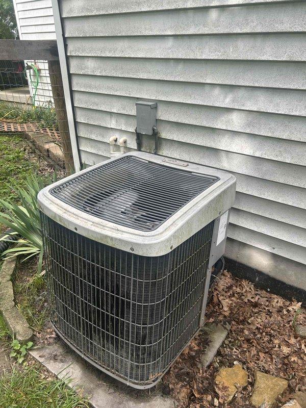 Responded to no cooling complaint on 20-year-old electric air conditioning system serving main level of residence. Performed comprehensive system evaluation of outdoor condensing unit and indoor air handler located in basement. Documented current equipment condition including weathered outdoor unit with debris accumulation and existing Honeywell thermostat. Based on system age exceeding manufacturer life expectancy and non-operational cooling status, provided full HVAC replacement estimate as GREEN option for complete system upgrade.