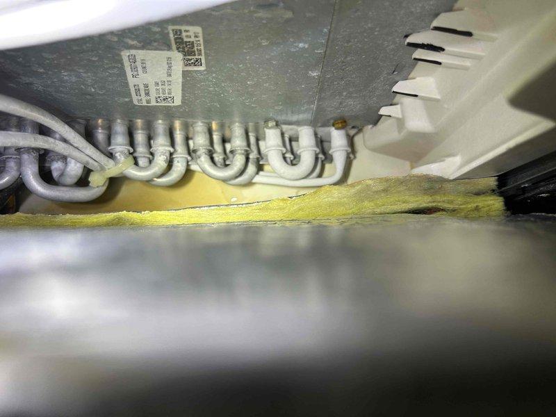 Responded to no cooling complaint on 6-year-old electric air conditioning system with indoor unit located in attic. Performed diagnostic inspection of evaporator coil assembly and refrigerant lines. Documented system components including serpentine coil configuration, refrigerant tubing, and insulation integrity. Verified recent filter change and assessed overall unit condition through visual inspection of internal components, fan housing, and mechanical compartment.