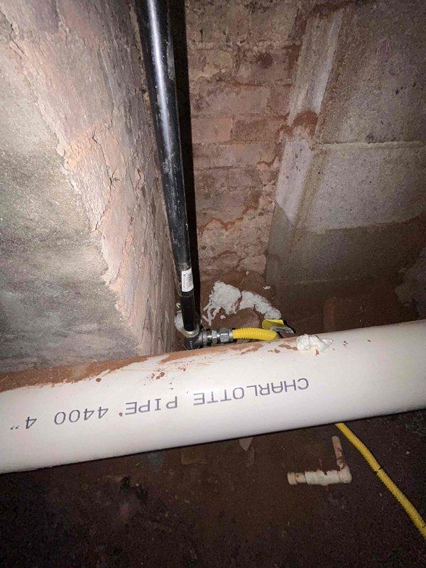 Completed tankless water heater installation in basement utility area requiring extensive infrastructure modifications. Drilled two exterior penetrations for fresh air intake and one for exhaust venting, then rerouted existing water supply and gas lines to accommodate new unit placement. Installed dedicated electrical outlet to power tankless system. Connected condensate drainage to existing sump pump alongside temperature and pressure relief valve discharge. Performed comprehensive leak testing on all water, gas, and condensate connections and verified proper operational functionality of the tankless water heater system before completing the installation.