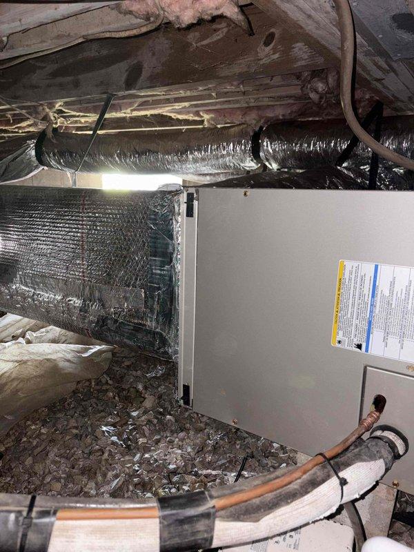 Completed full residential heat pump system installation in crawl space consisting of Bryant 2-ton 15 SEER2 single-stage outdoor heat pump unit (model GH5SAN52400A), Bryant air handler (model FJ5ANXA24L00), and 10KW auxiliary electric heat kit (model TU-EC-10BKB). Installed new digital thermostat for system control. Removed and properly disposed of existing HVAC equipment per environmental regulations.

Installation included outdoor unit placement on new concrete pad with snow legs for elevation and proper drainage. Installed electrical disconnect box at outdoor unit location and electrical whip kit for code-compliant power connection. Ran insulated refrigerant line set between outdoor heat pump and indoor air handler with inline refrigerant filter for system protection. Applied proper insulation to all refrigerant lines to prevent condensation and maximize efficiency.

Positioned air handler in crawl space with proper clearances for service access. Connected flexible silver insulated 