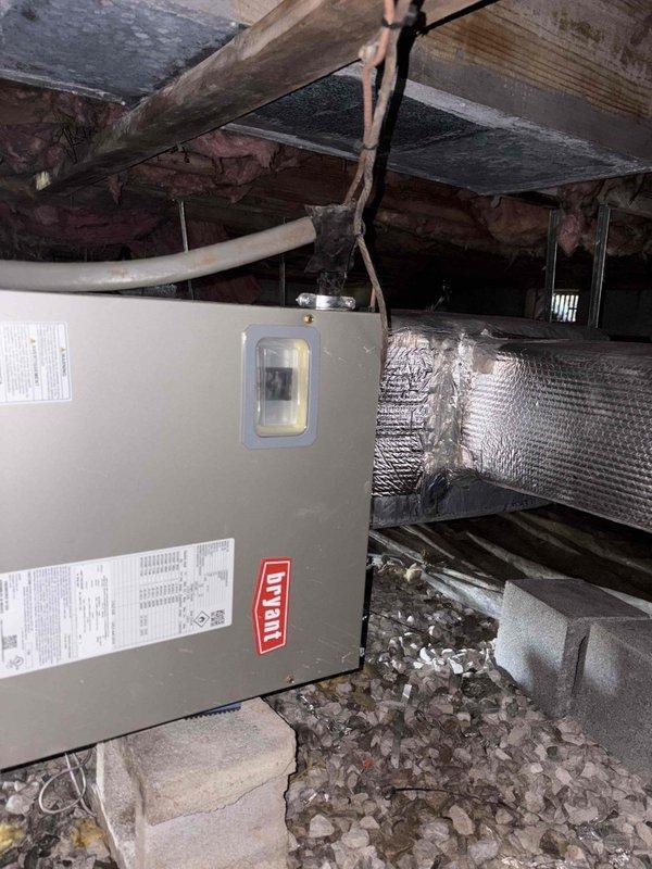 Completed full residential heat pump system installation in crawl space consisting of Bryant 2-ton 15 SEER2 single-stage outdoor heat pump unit (model GH5SAN52400A), Bryant air handler (model FJ5ANXA24L00), and 10KW auxiliary electric heat kit (model TU-EC-10BKB). Installed new digital thermostat for system control. Removed and properly disposed of existing HVAC equipment per environmental regulations.

Installation included outdoor unit placement on new concrete pad with snow legs for elevation and proper drainage. Installed electrical disconnect box at outdoor unit location and electrical whip kit for code-compliant power connection. Ran insulated refrigerant line set between outdoor heat pump and indoor air handler with inline refrigerant filter for system protection. Applied proper insulation to all refrigerant lines to prevent condensation and maximize efficiency.

Positioned air handler in crawl space with proper clearances for service access. Connected flexible silver insulated 