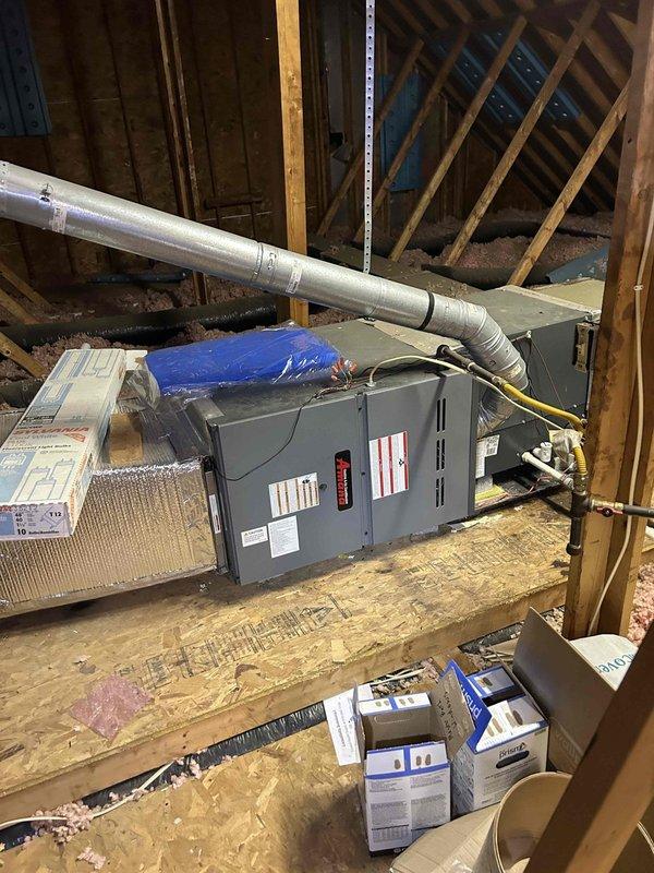 # HVAC Service Report

Responded to no-cool call for 15-year-old residential air conditioning system affecting entire home. Upon arrival, accessed attic-mounted air handler unit and performed diagnostic evaluation. Inspected internal components including control board with digital display and air filtration system. Noted blue mesh filter showing signs of debris accumulation and discoloration. Examined circuit board connections, wiring harness, and electrical components for proper operation. Documented equipment condition and internal components with photographs for service records.