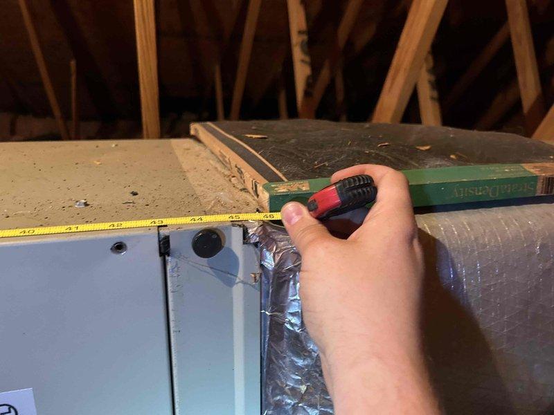 # HVAC Service Completed

Responded to a no cooling call on a 15-year-old air conditioning system. Upon arrival, performed diagnostic evaluation to identify the cause of cooling failure.

Initial inspection revealed severely restricted airflow due to heavy dust and debris accumulation throughout the return air system. Return grille showed significant buildup of airborne particles creating a matted layer on louvers and internal surfaces, indicating prolonged lack of maintenance. This restriction was substantially reducing system airflow and efficiency, contributing to the no cooling condition.

Proceeded to attic space to access air handling equipment and ductwork components. Evaluated air filter condition and accessibility. Due to deteriorated filter housing and compromised filter mounting system, fabricated custom filter rack assembly to ensure proper filtration and system protection going forward. Measured and cut materials on-site to create secure filter retention system that will m