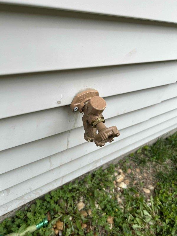 Responded to outdoor hose spigot leak causing water intrusion into the home. Upon inspection, identified compromised spigot assembly mounted on exterior siding with water penetrating through wall cavity. Accessed interior plumbing connections through service panel, revealing copper piping with threaded brass fittings showing signs of prolonged moisture exposure and deterioration. Repaired/replaced faulty spigot components and sealed penetration point to prevent further water migration into structure.