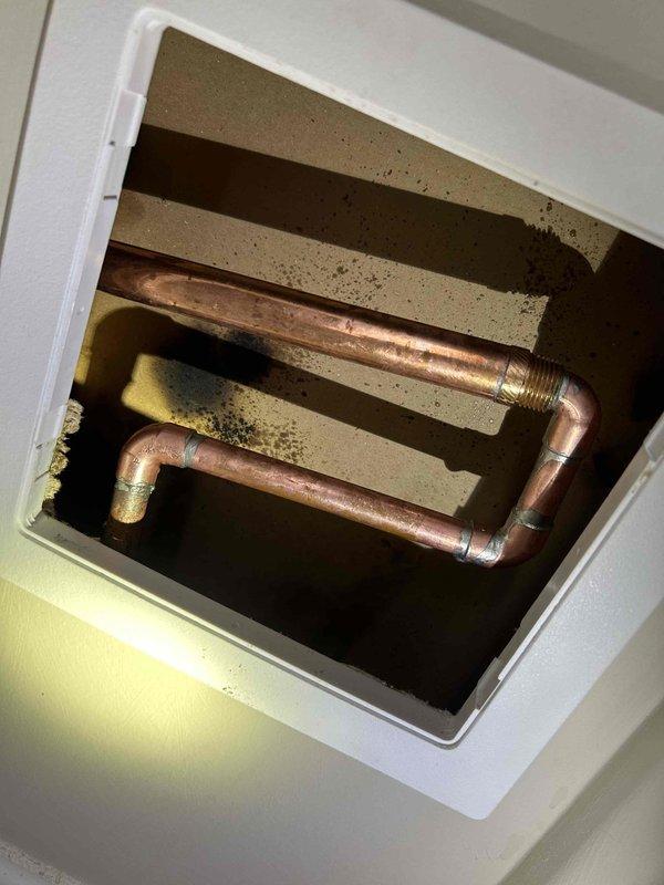 Responded to outdoor hose spigot leak causing water intrusion into the home. Upon inspection, identified compromised spigot assembly mounted on exterior siding with water penetrating through wall cavity. Accessed interior plumbing connections through service panel, revealing copper piping with threaded brass fittings showing signs of prolonged moisture exposure and deterioration. Repaired/replaced faulty spigot components and sealed penetration point to prevent further water migration into structure.