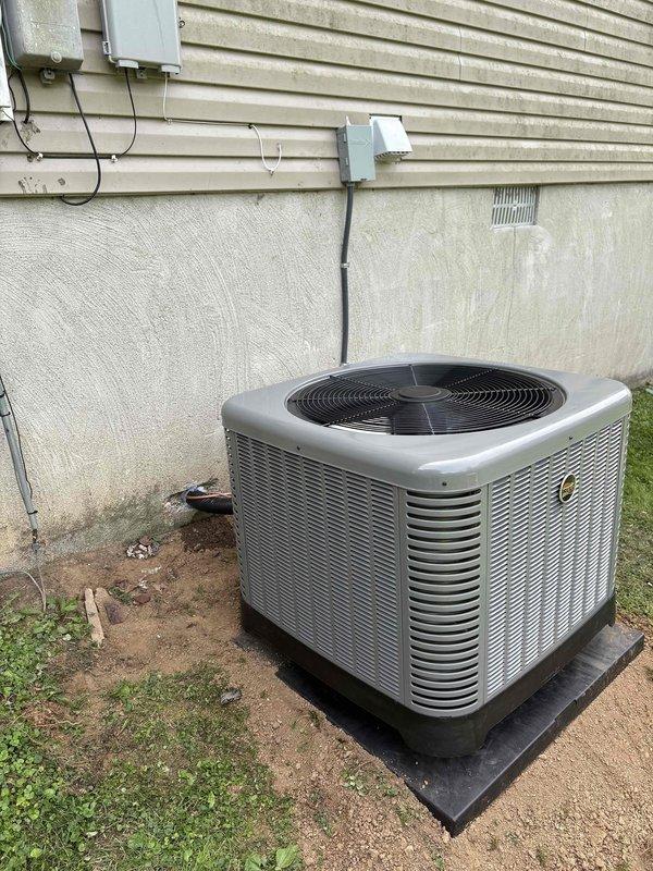 Completed full residential HVAC system replacement including installation of RUUD 2.5 ton 15.2 SEER2 two-stage heat pump (model RP14AY30AJ2NA), RUUD 2.5 ton air handler (model RH2TY3617STANNJ), and RUUD 10kW electric heat kit (model RXBH-1724A10J-B). Installed new 3/8x3/4 refrigerant line set connecting outdoor condenser unit to indoor air handler. Mounted heat pump on rubber isolation pad against exterior foundation with proper clearances and secured electrical disconnect and conduit to exterior wall. 

Positioned air handler in crawl space with proper clearances and accessibility for future service. Installed new condensate drain line with safety switch to prevent overflow damage. Upgraded digital thermostat for improved temperature control and system operation. Performed ductwork modifications including insulating return plenum with foil duct wrap to prevent condensation and improve efficiency. Replaced one 6-inch supply run with new foil-faced R6 flex duct to eliminate air leakage 