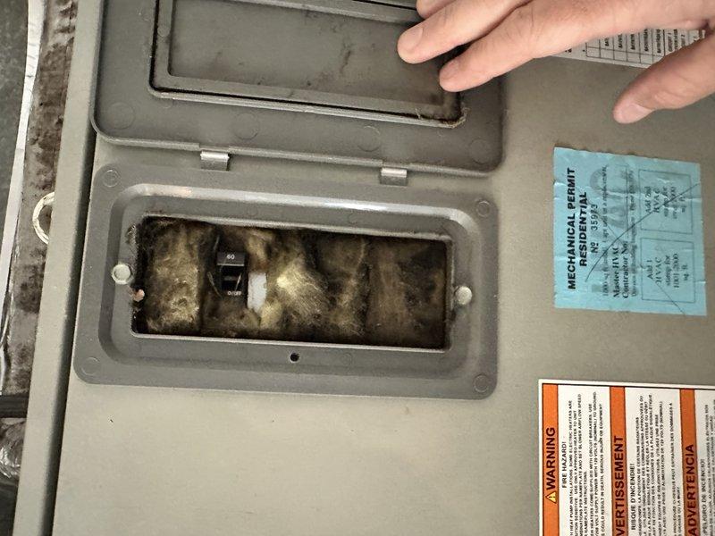 Responded to no-cool complaint on 17-year-old electric HVAC system experiencing frozen coil and restricted airflow for approximately one week. Upon inspection, found air handler unit with severely compromised airflow due to dirty conditions, contaminated electrical compartment with heavy dust and debris accumulation, and deteriorated insulation showing significant wear and staining. System age and overall condition indicated full replacement necessary rather than repair, and provided comprehensive replacement estimate for new equipment installation.