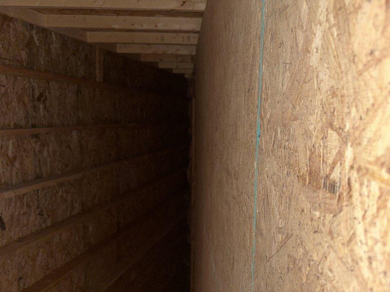 Conducted comprehensive site assessment for complete HVAC system replacement in pool house structure currently without existing equipment. Evaluated unfinished utility space with OSB wall construction and exposed framing to determine optimal placement for new indoor unit installation, documented existing conditions through detailed photography of installation area including structural supports and available mounting locations.