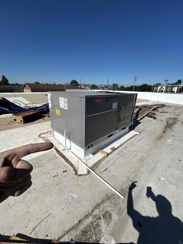 Installed a 10-ton used rooftop package unit on commercial building roof with knockdown flat roof curb. Fabricated and installed supply and return duct drops to connect unit to interior space, completing the HVAC system installation for the commercial facility.