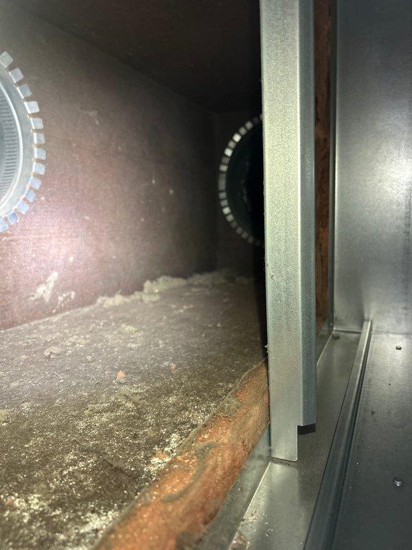 Completed comprehensive HVAC tune-up on furnace system with no reported operational issues. Upon inspection, discovered significant dust and debris accumulation throughout blower chamber and on interior metal surfaces, along with visible rust and corrosion on bottom chamber components. Inspected blower wheel, flexible ductwork connections, and interior cabinet condition; documented substantial buildup requiring future attention to maintain optimal system efficiency and prevent potential component degradation.