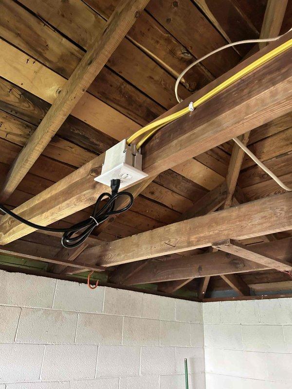 Responded to service call for lighting circuit modification in basement area. Multiple fixtures were previously controlled by a single switch, which limited operational flexibility. Installed new junction box and ran additional branch circuit wiring to separate fixture control, allowing independent operation of lighting zones. Routed yellow Romex cable along exposed ceiling joists and secured all connections per NEC standards. Verified proper operation of newly separated circuits and ensured all electrical boxes were properly mounted and accessible for future maintenance.