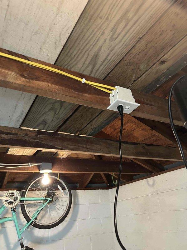 Responded to service call for lighting circuit modification in basement area. Multiple fixtures were previously controlled by a single switch, which limited operational flexibility. Installed new junction box and ran additional branch circuit wiring to separate fixture control, allowing independent operation of lighting zones. Routed yellow Romex cable along exposed ceiling joists and secured all connections per NEC standards. Verified proper operation of newly separated circuits and ensured all electrical boxes were properly mounted and accessible for future maintenance.