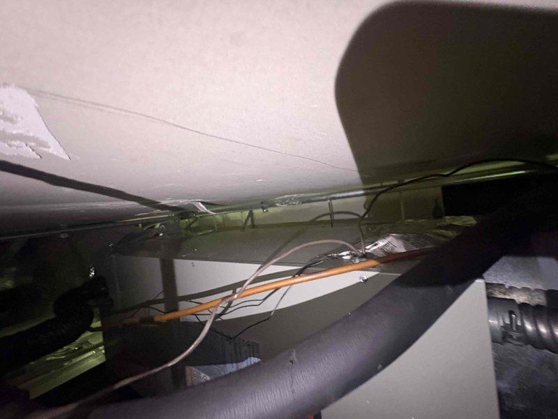 Returned to site to complete warranty work on second air handler system installed in drop ceiling location. Original three-phase heat kit was defective out of the box during initial installation and required factory replacement. Successfully installed new factory-ordered heat kit in air handler unit located in confined drop ceiling space. Verified proper electrical connections and tested system operation. Unit now functioning as designed with heat kit operational. Documentation photos captured of completed installation.