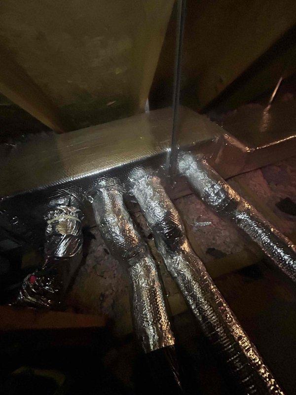 Responded to no cooling complaint on 2019-installed system consisting of Model 24ACC430A003 outdoor unit (Serial: 2919E13556) and Model CNPHP3017ALA air handler (Serial: 2219X46735). Previous contractor suspected ductwork issues. Upon inspection of attic-mounted indoor unit, discovered significant condensation accumulation on flexible ductwork at plenum junction points, indicating inadequate insulation and possible air leakage at duct connections. Observed moisture pooling on multiple supply ducts converging at central distribution point, with visible water droplets and dampness on metallic duct surfaces. Identified improperly supported flex duct runs with insufficient insulation barrier between conditioned air and attic ambient temperature. System equipment confirmed operational but cooling capacity compromised by duct losses and condensation issues causing reduced airflow and efficiency. Documented warranty status showing enhanced parts coverage active through 2029 for original owner