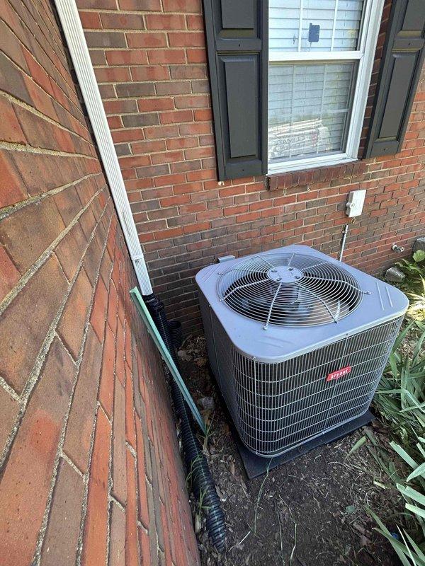 Completed full residential HVAC system replacement including installation of Bryant 3-ton 14.3 SEER2 single-stage heat pump with matching air handler and 10kw electric heat kit. Outdoor condenser unit positioned on pad against exterior brick wall with snow legs, electrical disconnect box, whip kit, insulated refrigerant lines, and line filter installed. Indoor air handler mounted vertically in utility closet with black flexible ductwork connections, PVC condensate drain line with trap, SS2 coil drain safety water sensor, ceiling saver overflow drain pan with water sensor, transition to existing ductwork, and standard air filter rack. All electrical connections completed to code, refrigerant lines properly insulated and charged, system tested and operational. Existing equipment removed and disposed of, all applicable permits obtained, installation meets code compliance requirements with 1-year labor and 10-year parts warranty.