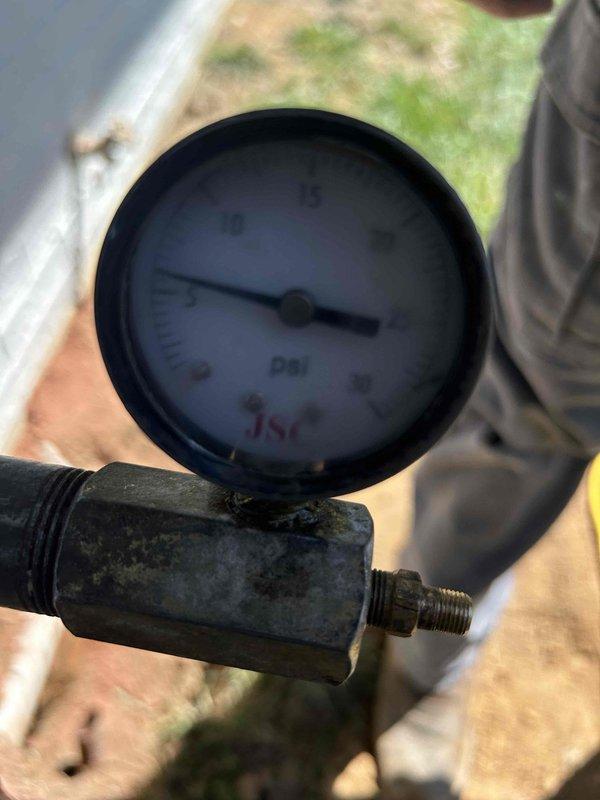 Responded to gas leak emergency after utility company identified leak and shut off gas service. Located and isolated leak in gas line running along exterior garage wall. Opened interior wall cavity to access compromised gas piping, exposed framing and existing infrastructure for proper assessment. Conducted pressure test using calibrated gauge to verify system integrity and confirm leak location. Demonstrated isolated leak section to customer and explained repair requirements. Installed new gas line section over two-day period to replace damaged piping and restore safe gas service to residence.