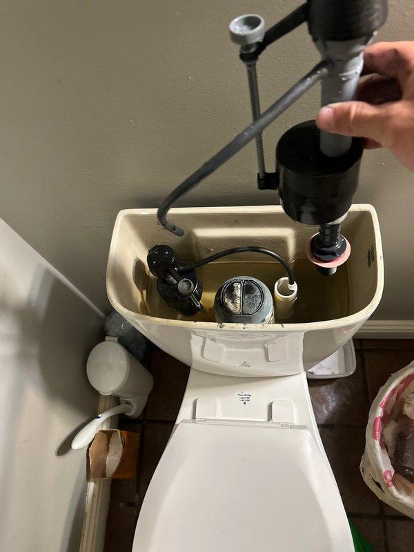 Responded to main bathroom toilet with continuous water flow issue affecting modern dual-flush mechanism. Upon inspection, identified malfunctioning flush valve assembly causing improper seal and constant water running into bowl. Removed tank lid, diagnosed failed flush valve seal component, and replaced defective parts within the flush mechanism. Tested fill valve operation, adjusted water level, and verified proper shutoff function. Cycled flush system multiple times to confirm complete water shutoff and proper tank refill. Unit now operating normally with no further water flow issues detected.