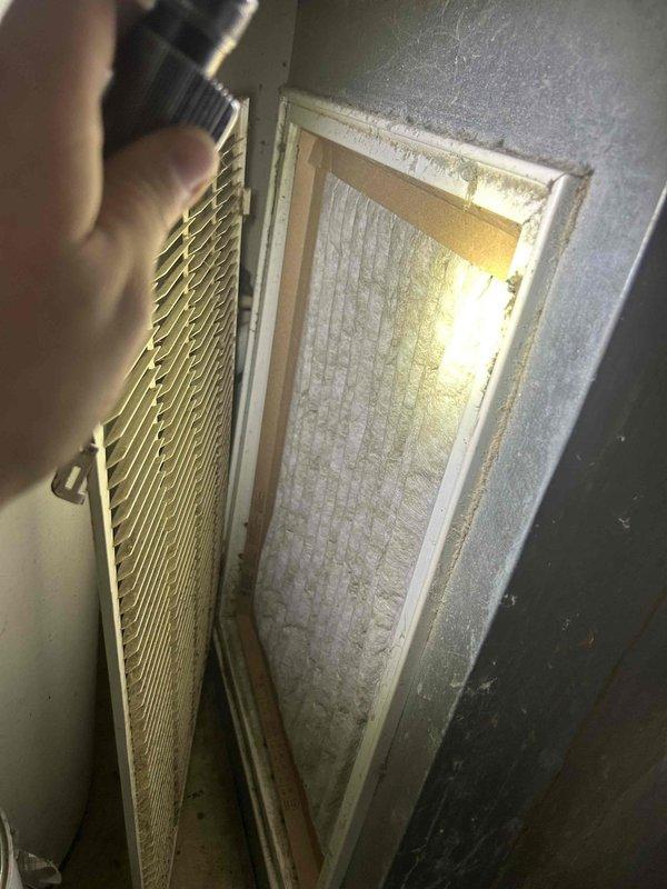 Responded to no cooling call on 2-year-old Payne electric AC system. Upon arrival, found heavily soiled air filter restricting airflow to the indoor air handler unit. Removed and inspected dirty filter showing significant dirt accumulation and discoloration. Replaced filter with new media to restore proper airflow. Verified system operation and confirmed unit now responding and cooling properly. Advised on importance of regular filter maintenance to prevent future airflow restrictions and system failures.
