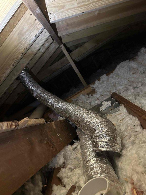 Conducted site assessment of small attic space to provide estimate for connecting or adding exhaust fan ventilation. Inspected existing electrical infrastructure, including wall-mounted outlets and wiring within exposed stud cavities with fiberglass insulation. Evaluated attic conditions including wooden joist structure, existing flexible metallic ductwork (approximately 6-8 inches diameter), and loose-fill insulation coverage. Documented current electrical access points and determined feasibility for exhaust fan installation and power supply routing through available wall cavities and attic space.